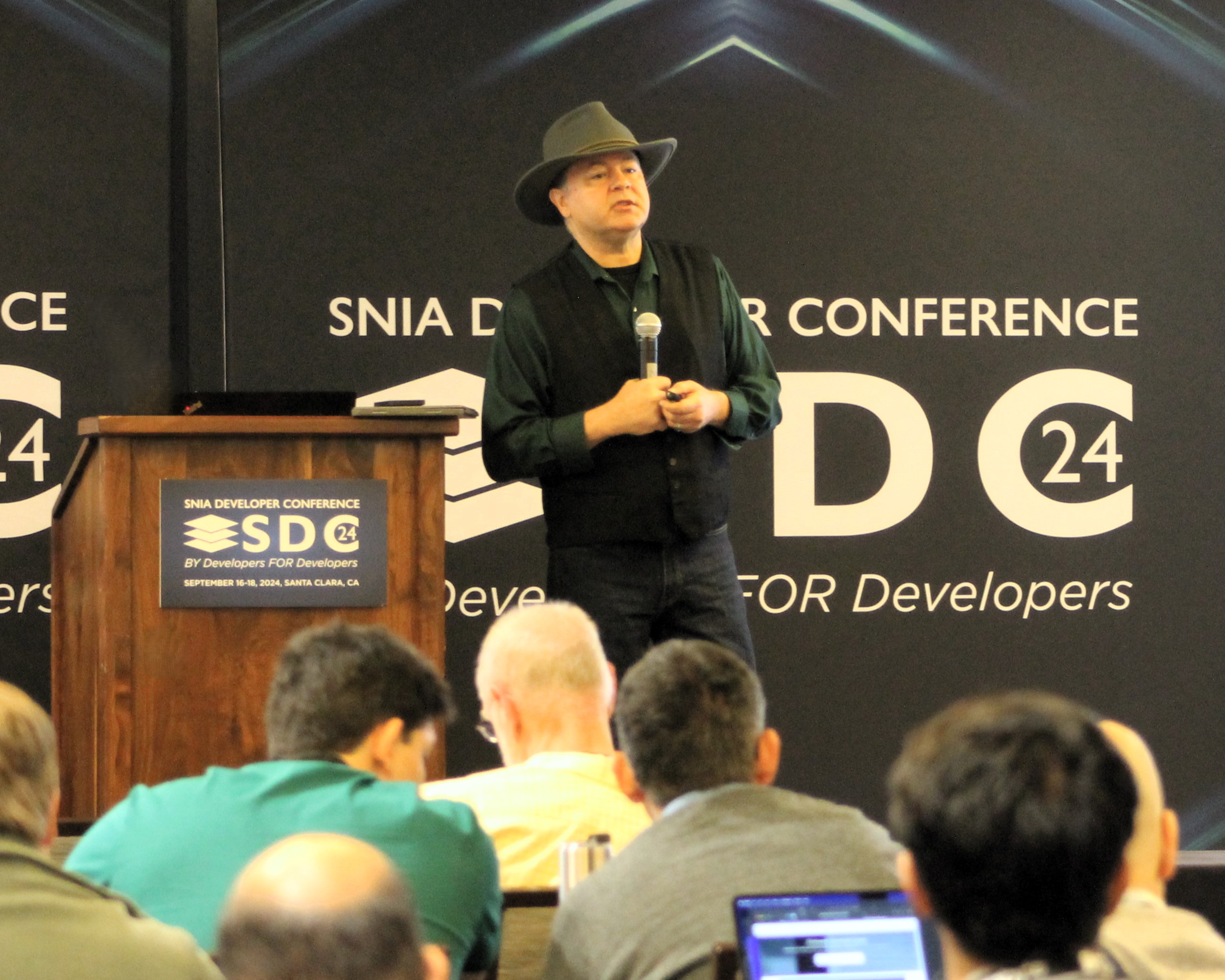 Presenter at the podium of the SNIA Developer Conference (SDC 24) in front of the audience